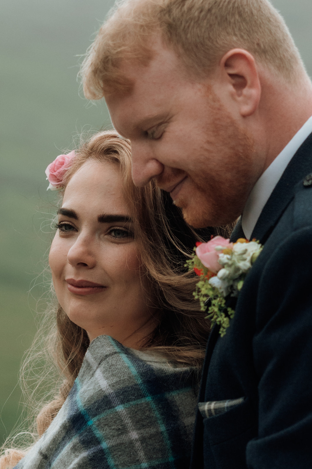 Bride close-up portrait with groom behind her at Isle of Arran elopement.