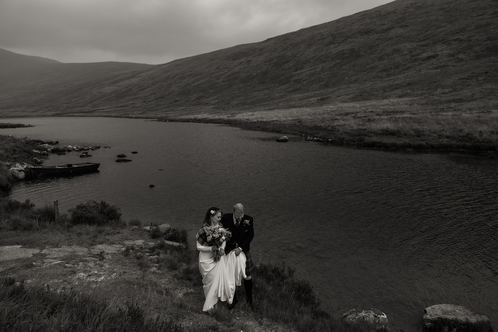 Black and white photo of couple walking by Loch Iorsa during Isle of Arran elopement.