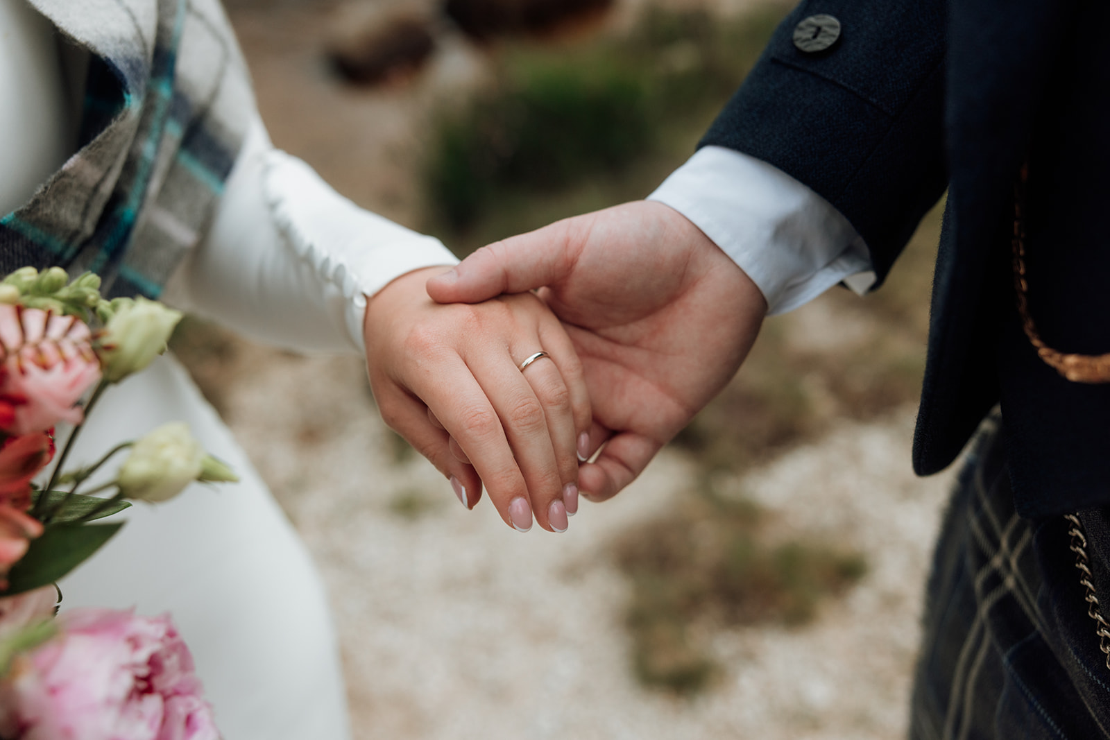 Close-up of bride and groom holding hands during Isle of Arran elopement.