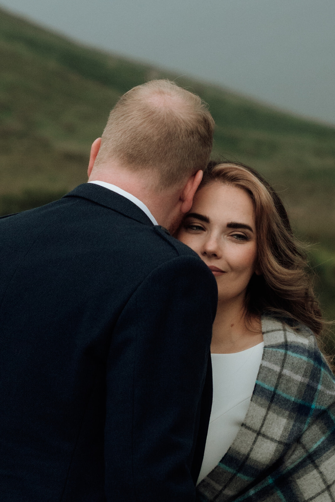 Groom kissing bride’s forehead during Isle of Arran elopement.