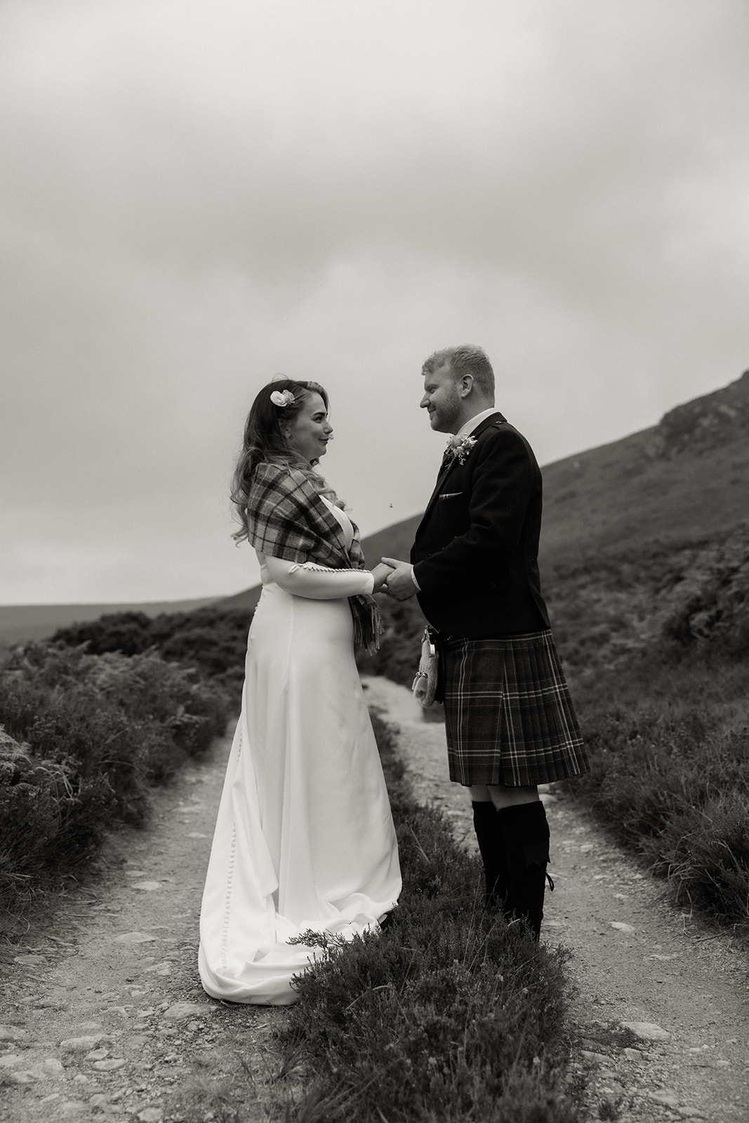 Black and white photograph of bride and groom standing together during Isle of Arran elopement.
