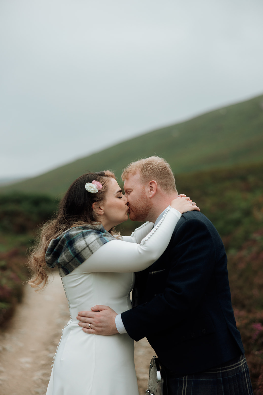 Close-up of bride and groom kissing outdoors during Isle of Arran elopement.