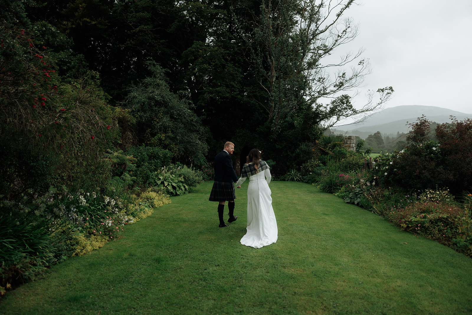 Bride and groom standing together in garden during Isle of Arran elopement.