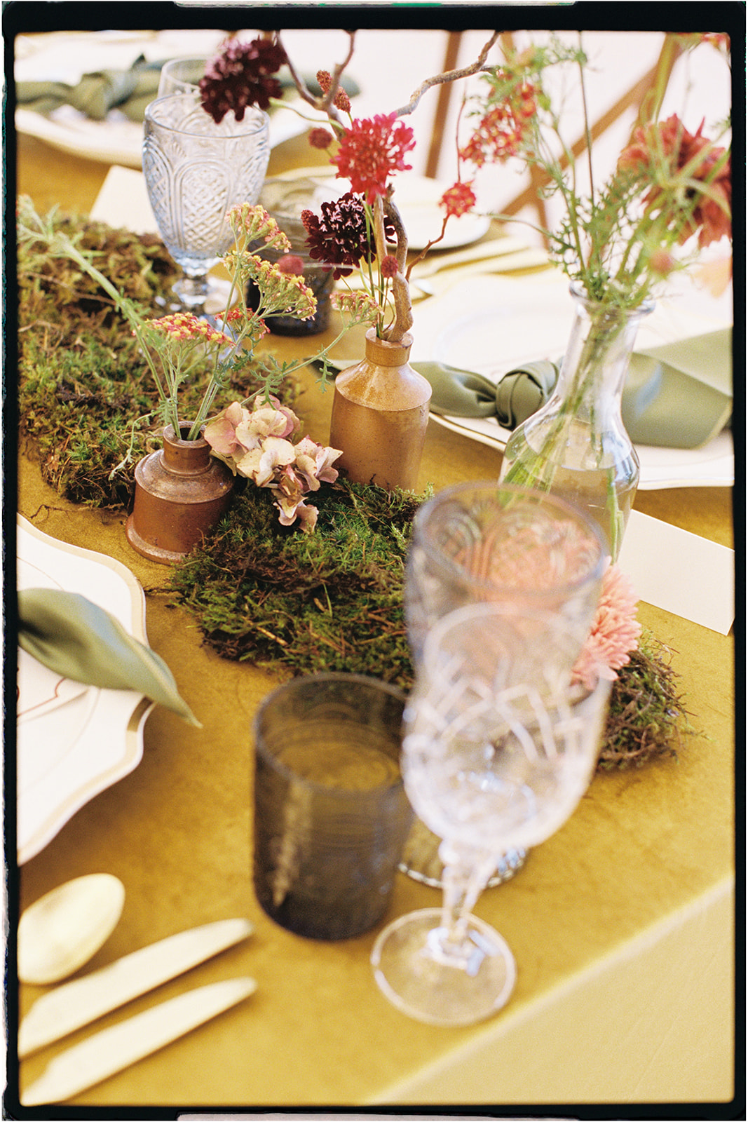 Close-up of floral table design with glassware and soft yellow tones, styled by Tupelo Tree in Scotland.