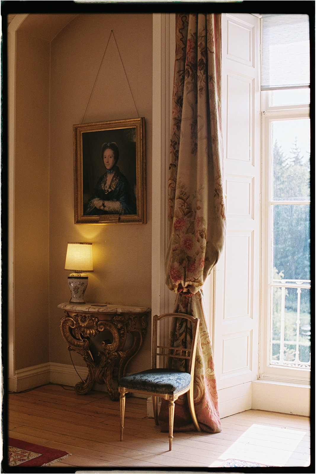 Ornate heritage room inside Winton Castle with portrait paintings and soft natural light.