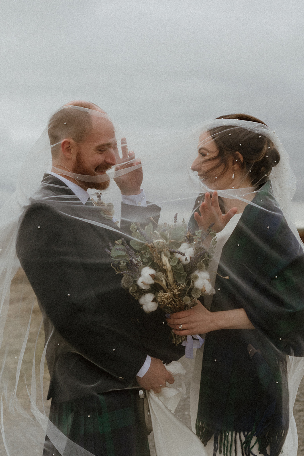 A moment of fun between Bride and Groom under the veil after their Unforgettable Intimate Wedding in the beautiful Shetland Islands