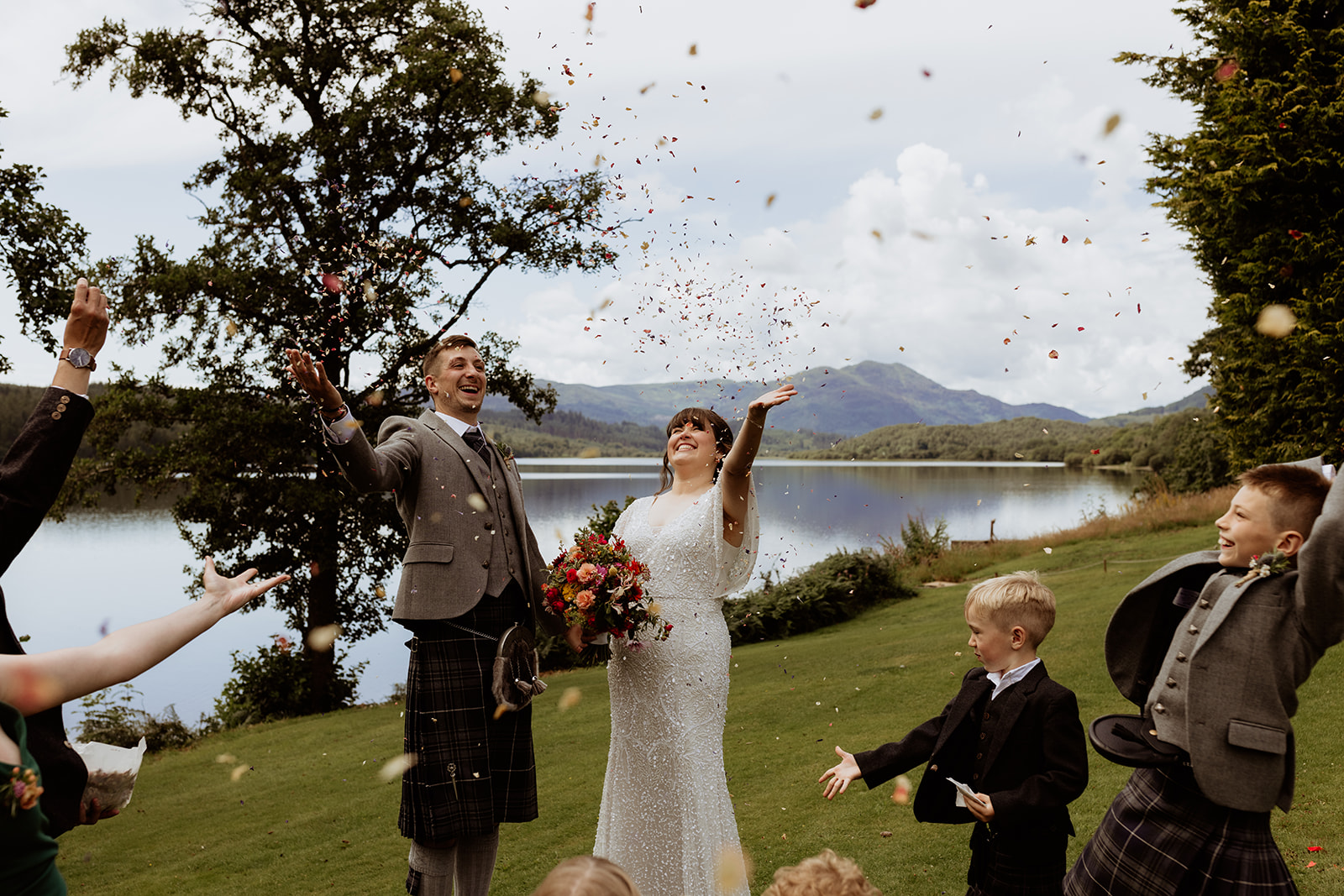 bride and groom celebrate Scottish Highland elopement with confetti